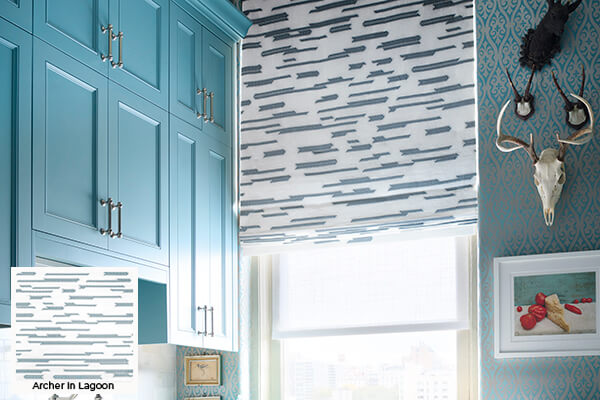 Geometric patterns, one of the window treatment trends 2026, is seen in this kitchen's asymmetrically Flat Roman Shade design