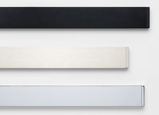 Three drapery hardware options in various Lexington finishes laid out on a white table top