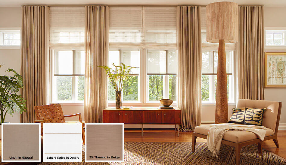 A very popular trend for window treatments and a great window drapery idea is layering different styles as seen in this living room's drapery and shades