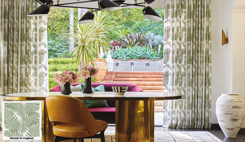 Floral patterns, one of the window treatment ideas popular in 2026, is seen in this dining room's palm pattern Tailored Pleat Drapery