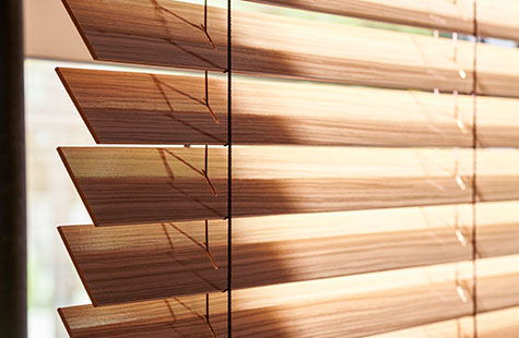 Wood Blinds in Exotic Zebrano show the texture of the linear slats, showing the difference between blinds vs drapery