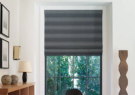 A contemporary space features privacy shades in a Flat Roman Shade style made of Victoria Hagan's Jasmine in bold Midnight as elegant window coverings with blackout lining