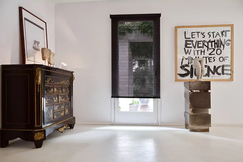 Hallway with tall window and semi-transparent solar shade, highlighting different types of window shades designed for light filtering and UV control